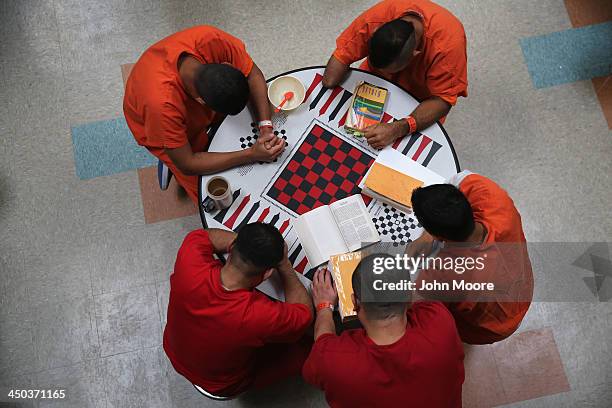 Immigrant detainees pray during a prayer group in a general population block at the Adelanto Detention Facility on November 15, 2013 in Adelanto,...