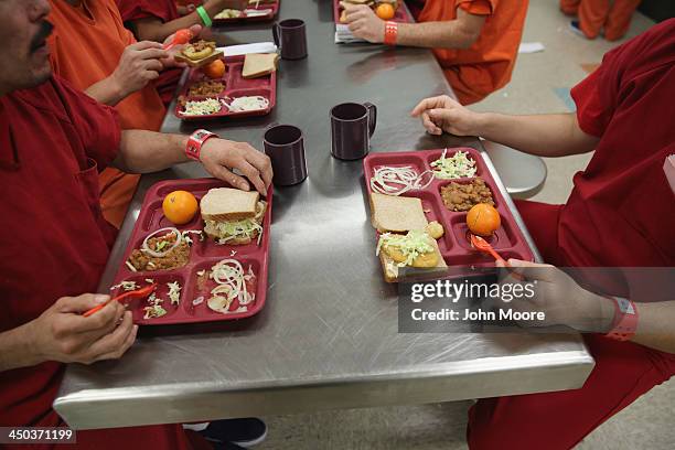 Immigrant detainees eat lunch, one of three meals a day at the Adelanto Detention Facility on November 15, 2013 in Adelanto, California. The...