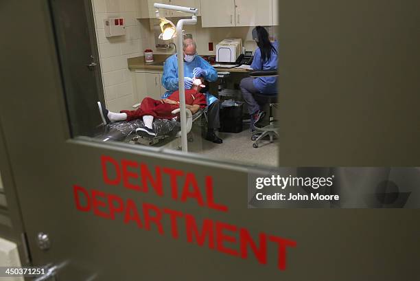 An immigrant receives dental care at the Adelanto Detention Facility on November 15, 2013 in Adelanto, California. The center, the largest and newest...