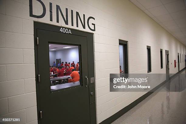 Immigrant detainees eat lunch, one of three meals a day, at the Adelanto Detention Facility on November 15, 2013 in Adelanto, California. The...