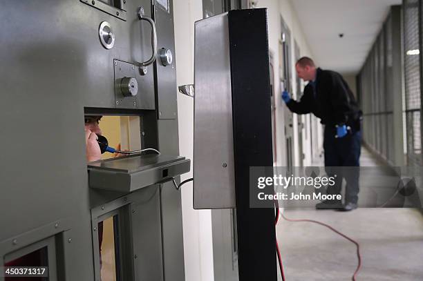 An immigrant detainee makes a call from his 'segregation cell' at the Adelanto Detention Facility on November 15, 2013 in Adelanto, California....