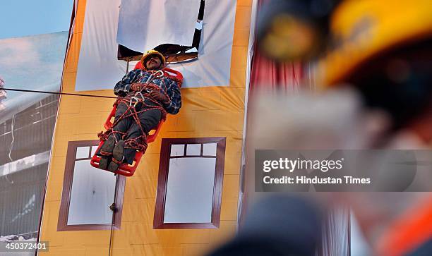 Patient carried on a stretcher into an ambulance during a Mock earthquake rescue drill at India International Trade Fair on November 18, 2013 in New...