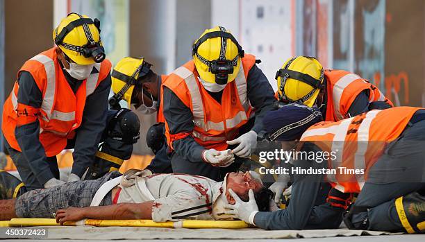 Patient carried on a stretcher into an ambulance during a Mock earthquake rescue drill at India International Trade Fair on November 18, 2013 in New...