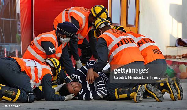 Patient carried on a stretcher into an ambulance during a Mock earthquake rescue drill at India International Trade Fair on November 18, 2013 in New...