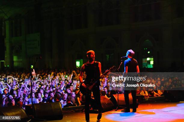 Zach Blair and Tim McIlrath of Rise Against performs on stage during Vans Warped Tour 2013 at Alexandra Palace on November 17, 2013 in London, United...