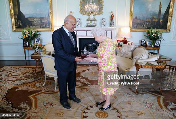 Queen Elizabeth II receives Sir Magdi Yacoub during an audience at Buckingham Palace where he presented the Insignia of a member of the Order of...