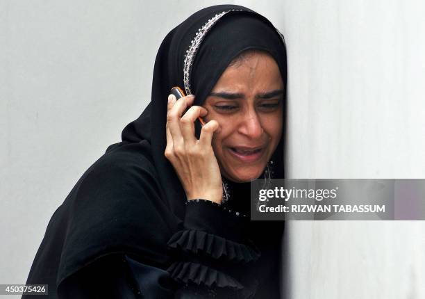 Pakistan woman mourns at the morgue, the death of a relative who was found inside the premises of a cold-storage cargo facility at the Jinnah...