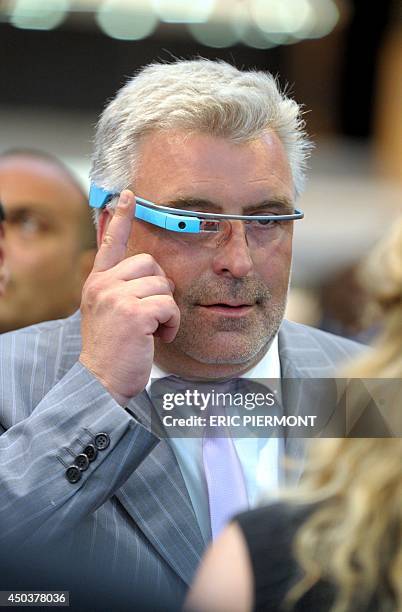 French junior minister for Transport, Maritime Economy and Fishery Frederic Cuvillier tries on "Google Glass" while visiting the "Transports Publics...