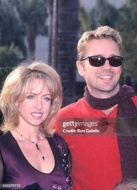 Actor John Schneider and wife Elly Castle attend the "Snow Day" Hollywood Premiere on January 29, 2000 at Paramount Theatre, Paramount Pictures...