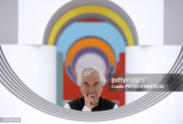 French artist Daniel Buren poses on June 10, 2014 in front of his installation entitled "Comme un jeu d'enfant, travaux in situ" at the Musee d'Art...