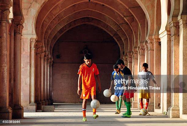 Football players practicing at Allahabad University campus on June 10, 2014 in Allahabad, India. Football fever is griping the sport fans in the...