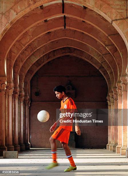 Football players practicing at Allahabad University campus on June 10, 2014 in Allahabad, India. Football fever is griping the sport fans in the...