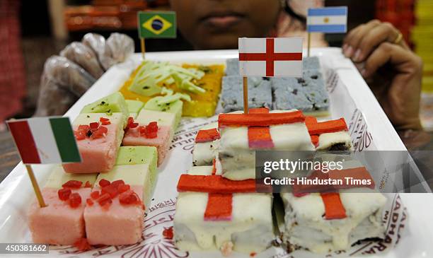 Sandesh made with the flags of the participating countries in the 'World Cup' being exhibited for sale at a sweet shop 'Balarams' on June 9, 2014 in...