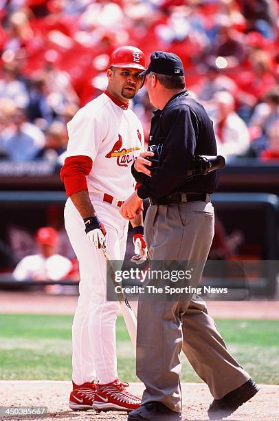 Albert Pujols of the St. Louis Cardinals argues with umpire Tim Welke during the game against the Cincinnati Reds at Busch Stadium on May 18, 2002 in...