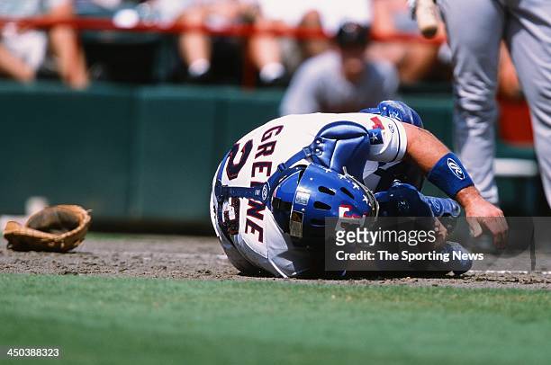 Todd Greene of the Texas Rangers gets injured during the game against the Houston Astros at The Ballpark in Arlington on September 2, 2002 in...