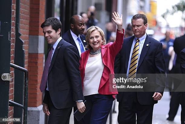 Former US Secretary of State Hillary Clinton greets the people as she enters the Barnes & Noble bookseller from the back door for the organization...