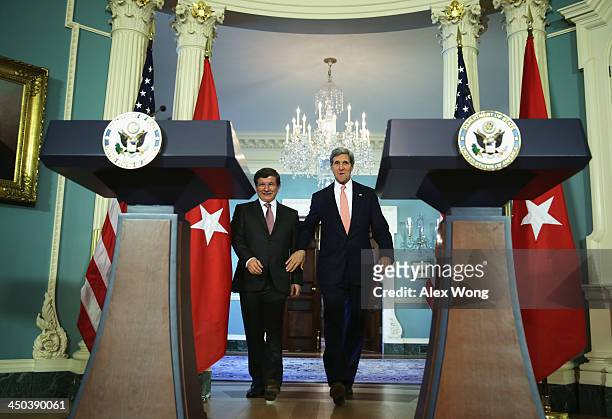 Secretary of State John Kerry and Turkish Foreign Minister Ahmet Davutoglu walk towards the podiums for a joint press availability November 18, 2013...
