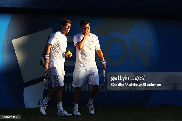 Ken Skupski of Great Britain and Neal Skupski of Great Britain talk during their Men's Doubles match against Grigor Dimitrov of Bulgaria and Stan...