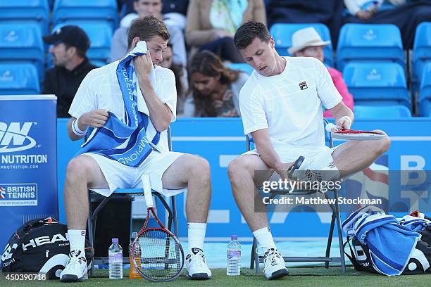 Ken Skupski of Great Britain and Neal Skupski of Great Britain talk during their Men's Doubles match against Grigor Dimitrov of Bulgaria and Stan...