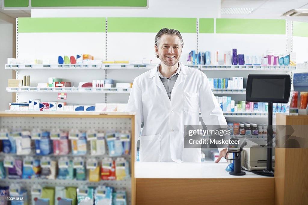 Smiling Pharmacist behind the counter