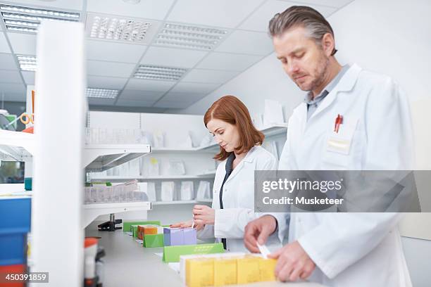 pharmacists labelling drugs - labelling stock pictures, royalty-free photos & images