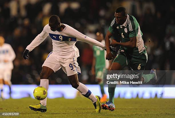 Mario Balotelli of Italy battles with Azubuike Egwuekwe of Nigeria during an International Friendly match between Italy and Nigeria at Craven Cottage...
