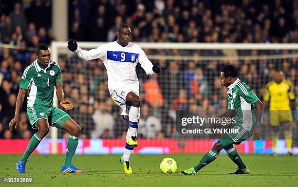 Italy's striker Mario Balotelli is challenged by Nigeria's midfielder Ogenyi Onazi and defender Azubuike Egwuekwe during the International friendly...