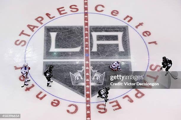 The New York Rangers skate over the center ice logo against the Los Angeles Kings during Game One of the 2014 NHL Stanley Cup Final at the Staples...