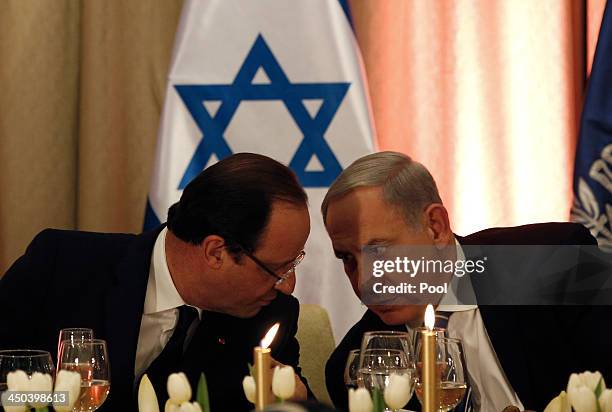 France's President Francois Hollande speaks with Israel's Prime Minister Benjamin Netanyahu at an official state dinner hosted by Israel's President...