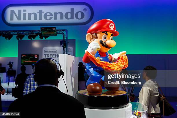 Large-scale figurine of Mario promotes Nintendo Co.'s Amiibo collectible characters featuring NFC technology during the E3 Electronic Entertainment...