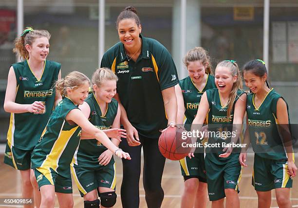 Liz Cambage plays basketball with girls from the Dandenong Rangers during a Dandenong Basketball Association announcement at Melbourne Sports and...