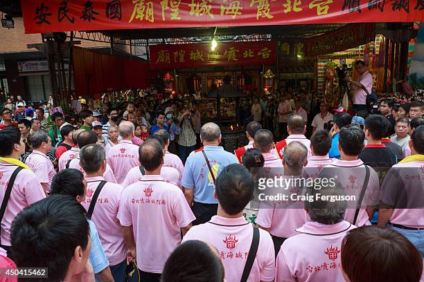 Officials from the Xiahai Temple pray outside it to commemorate their main God's birthday. The Xiahai Temple is the seat of the Taipei City God.