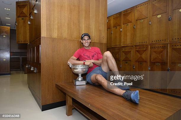 Rafael Nadal of Spain poses in the locker room with the Coupe des Mousquetaires trophy after the men's singles final against Novak Djokovic of Serbia...