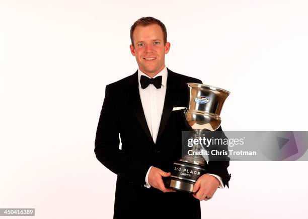 Nationwide Series driver Regan Smith poses with his third place trophy during the NASCAR Nationwide Series/Camping World Truck Series banquet at the...