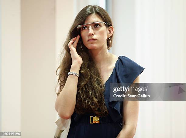 Young woman wears Google Glass at an unrelated book presentation and media event on June 10, 2014 in Berlin, Germany. Google Glass, which films what...