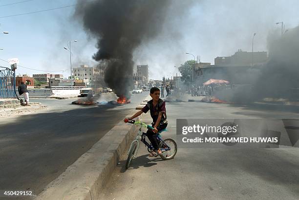 Yemeni boy rides his bike during a protest demanding basic services from the government on June 11 in the capital Sanaa. The absence of reliable...