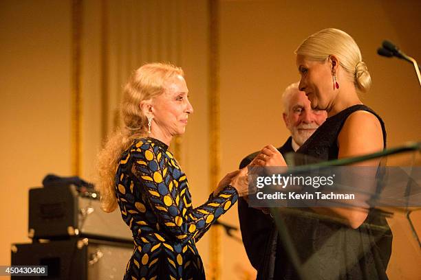 Crown Princess Mette-Marit of Norway and Editor-in-chief of Vogue Italia Franca Sozzani greet each other onstage during the amfAR Inspiration Gala...