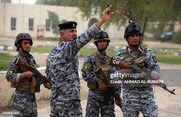 Iraqi policemen are seen on patrol inside a military base in Baghdad, on June 11 after the parliament had received a joint request from Iraqi Prime...