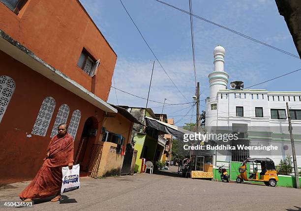 Woman walks through Java Lane in the Beira Lake district on November 18, 2013 in Colombo, Sri Lanka. Many residents in the area face eviction to make...