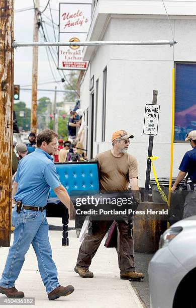 Men remove a booth from Uncle Andy's in South Portland on June 10 ...