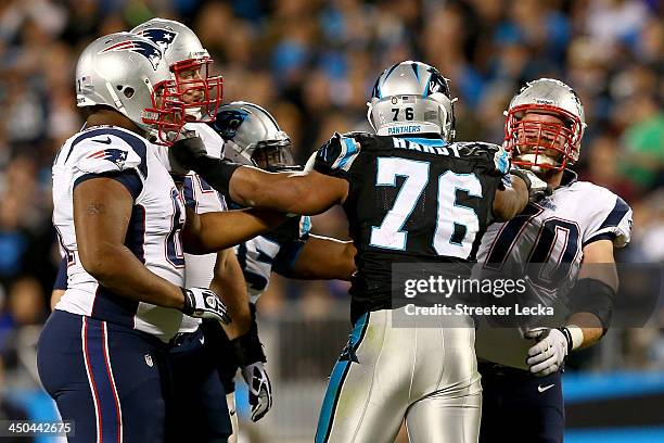 Defensive end Greg Hardy of the Carolina Panthers pushes guard Logan Mankins of the New England Patriots in the first half at Bank of America Stadium...