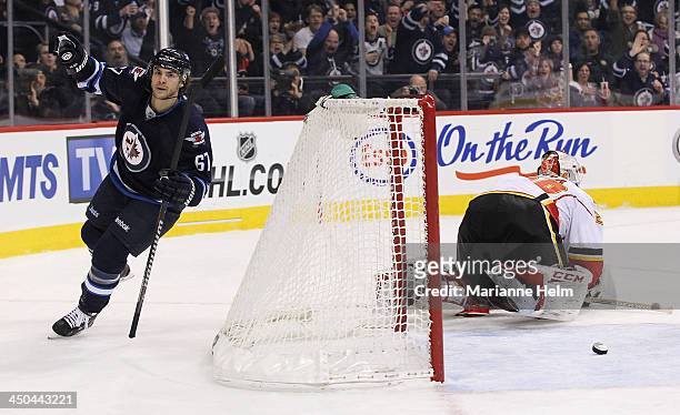 Michael Frolik of the Winnipeg Jets celebrates his goal against Reto Berra of the Calgary Flames in second period action in an NHL game at the MTS...