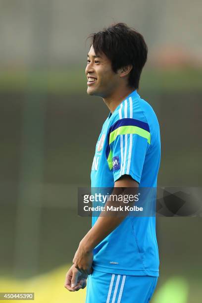 Atsuto Uchida smiles as he watches on during a Japan training session at the Japan national team base camp at the Spa Sport Resort on June 11, 2014...