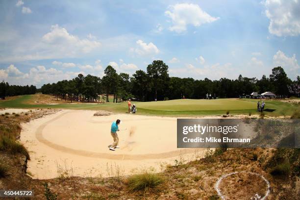 Gonzalo Fernandez-Castano of Spain hits a shot from a greenside bunker during a practice round prior to the start of the 114th U.S. Open at Pinehurst...