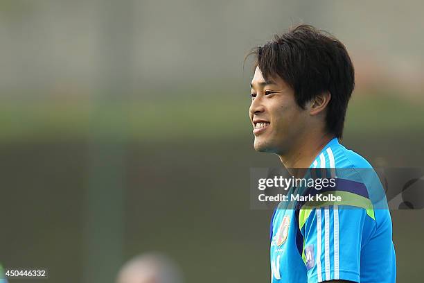 Atsuto Uchida smiles as he watches on during a Japan training session at the Japan national team base camp at the Spa Sport Resort on June 11, 2014...