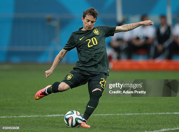 Bernard of Brazil kicks the ball during a Brazil training session ahead of the 2014 FIFA World Cup Brazil opening match against Croatia at Arena de...