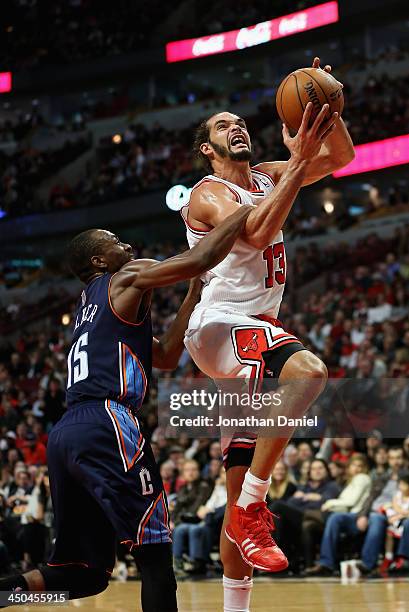 Joakim Noah of the Chicago Bulls is fouled by Kemba Walker of the Charlotte Bobcats at the United Center on November 18, 2013 in Chicago, Illinois....