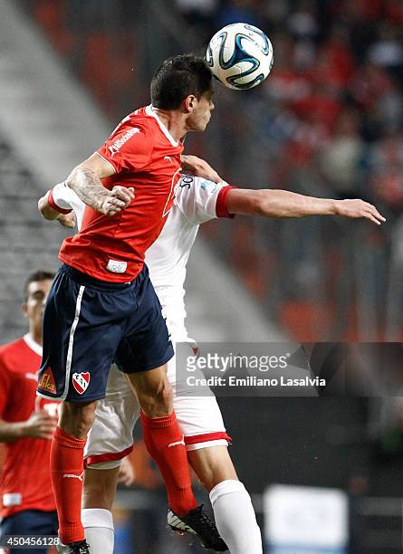 Cristian Tula of Independiente jumps to head the ball during a tie-breaker match between Independiente and Huracan at Ciudad de La Plata Stadium on...