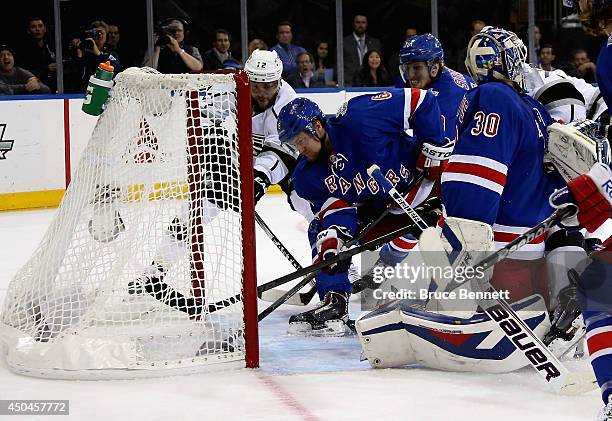 Anton Stralman of the New York Rangers sweeps the puck away from the goalline and Marian Gaborik of the Los Angeles Kings during the first period of...