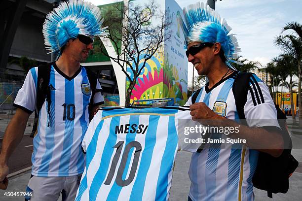 Argentina fans parade a Lionel Messi jersey around the front of Maracana stadium as the 2014 FIFA World Cup nears on June 11, 2014 in Rio de Janeiro,...